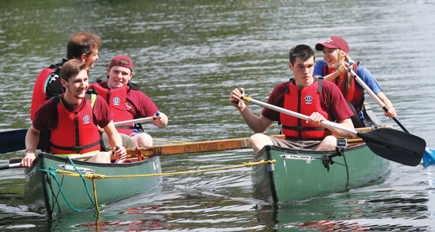 The Queen Elizabeth Hospital team paddle Canadian canoes