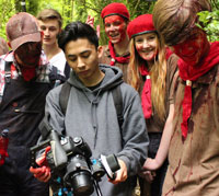 Students check out film footage on the Scrawl set