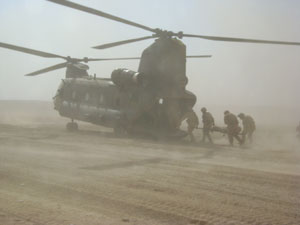 Peter being stretchered into a helicopter after hitting an IED in Afghanistan