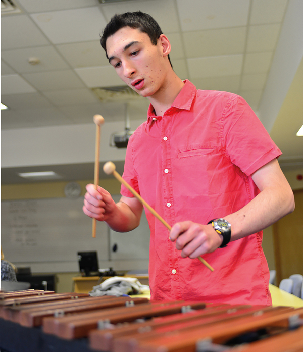 Chris Grabham playing a xylophone during a practice session