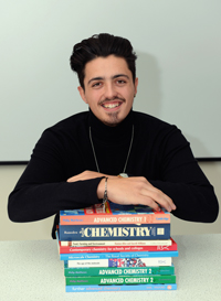 Edward with his chemistry books which he hopes will lead him to a career in medicine