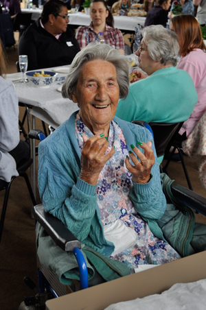 Nursing home resident Doris Russell shows off her newly painted nails