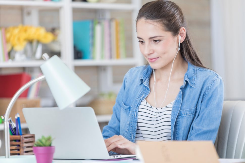 College student listens to music while studying | FE Week