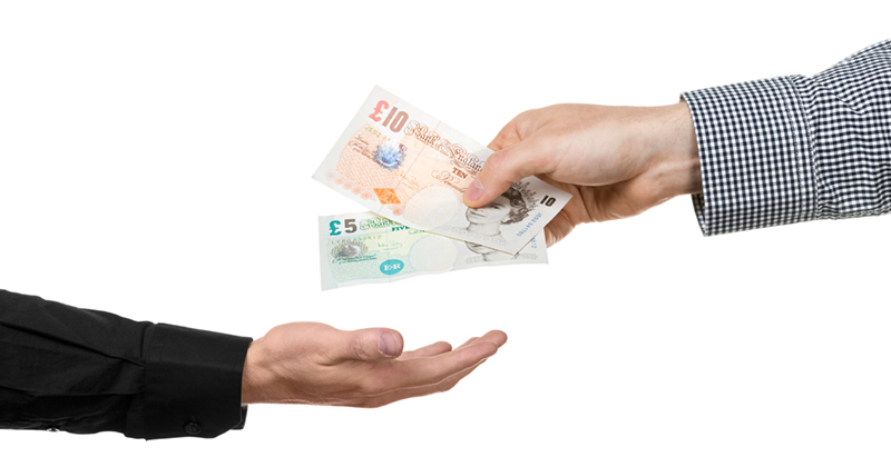 Man hands over british pound banknotes to another man | FE Week